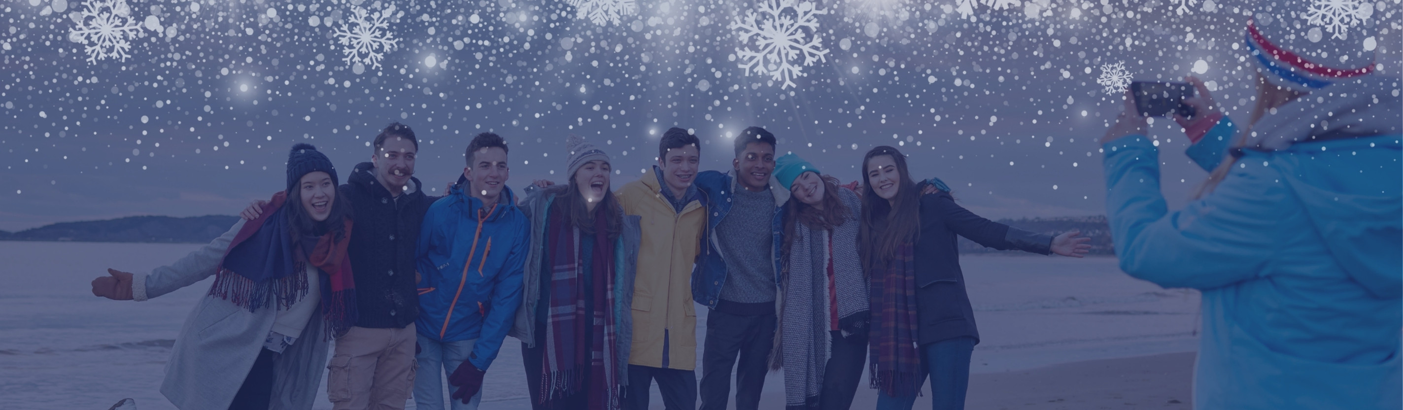 Students taking pictures on the beach