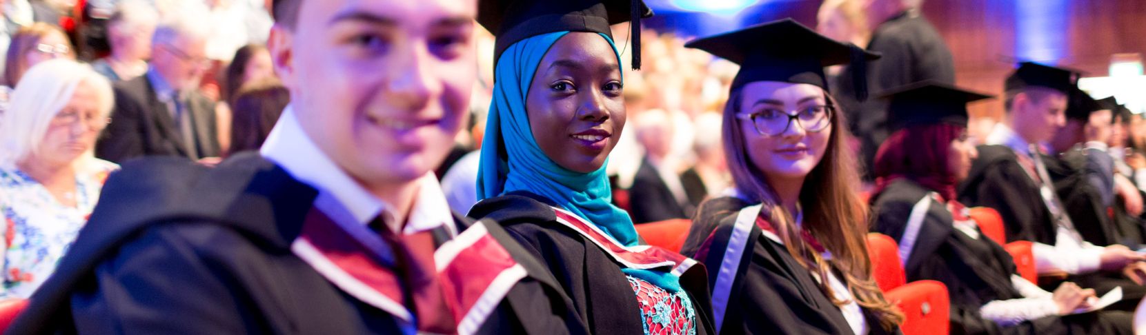 Students wearing cap and gown at ceremony