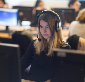 Female student on computer with head set