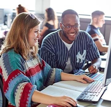 Two people sat at a computer