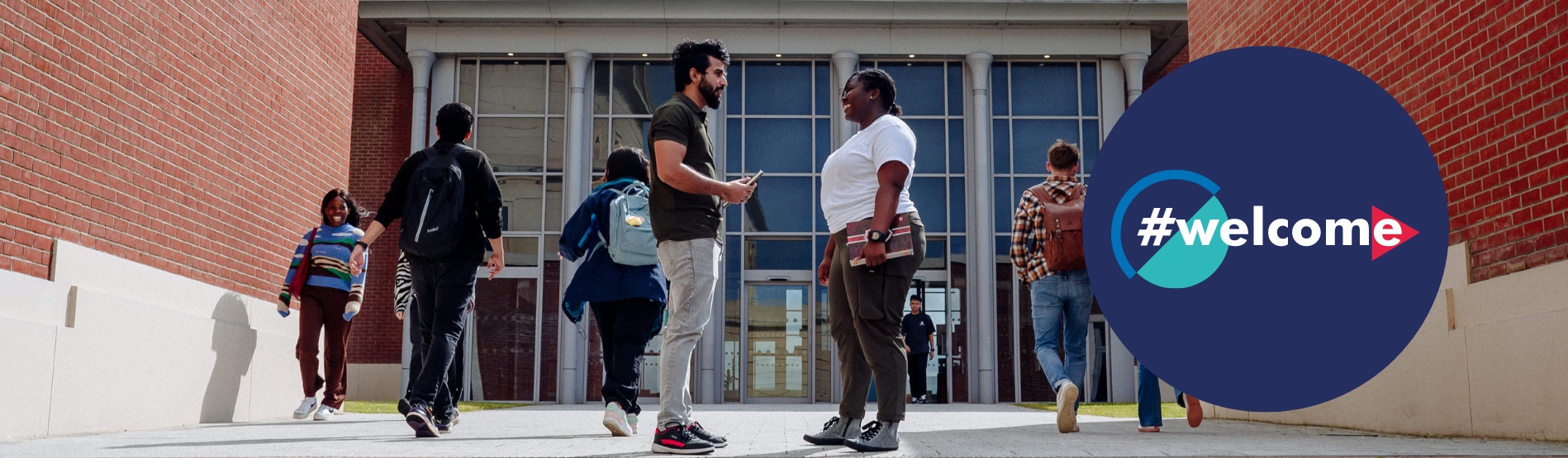 Students greeting each other outside Bay Library