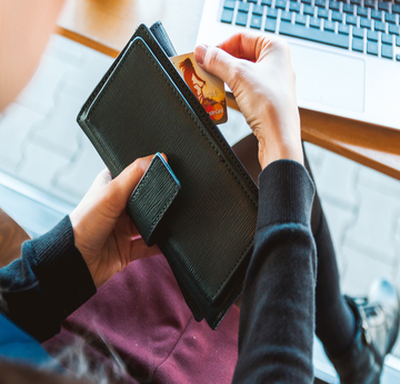 Women taking credit card out of wallet