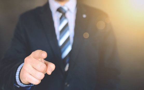 Man in suit pointing his finger.