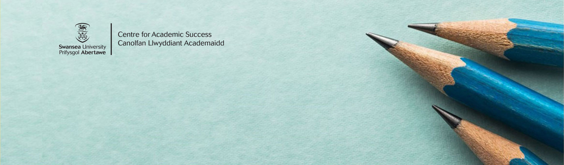 Pencils on green background