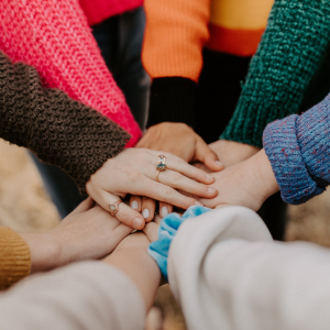 People's hands on top of each other
