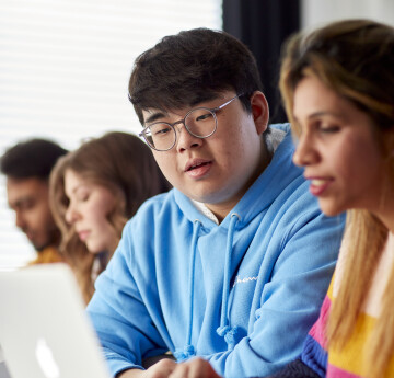 Two students looking at laptop