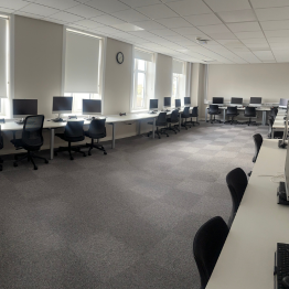 A PC lab with multiple pcs in the Nanhyfer building on Swansea University's Bay Campus