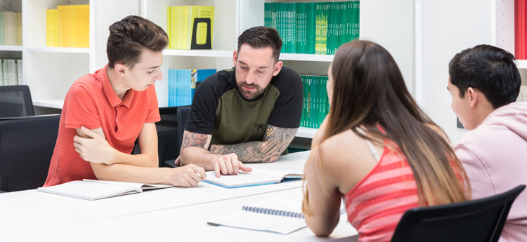 Students working in a group around a table