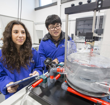 Male and female students running an experiment