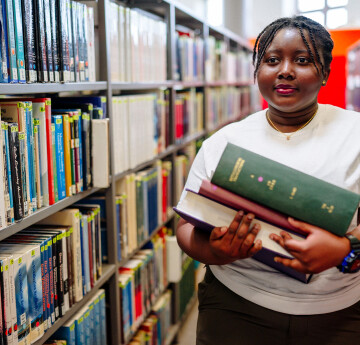 Student walking in Library.