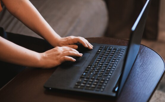 Photo of person typing on laptop