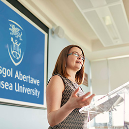 Female member of staff standing at front of class