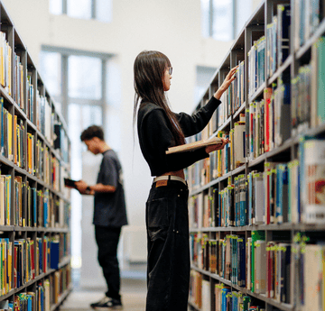 student choosing a book in the library 