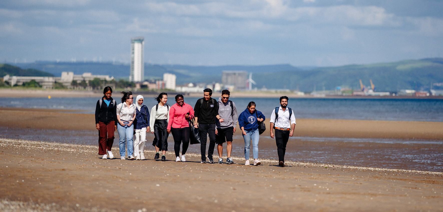 image of students walking on Swansea beach